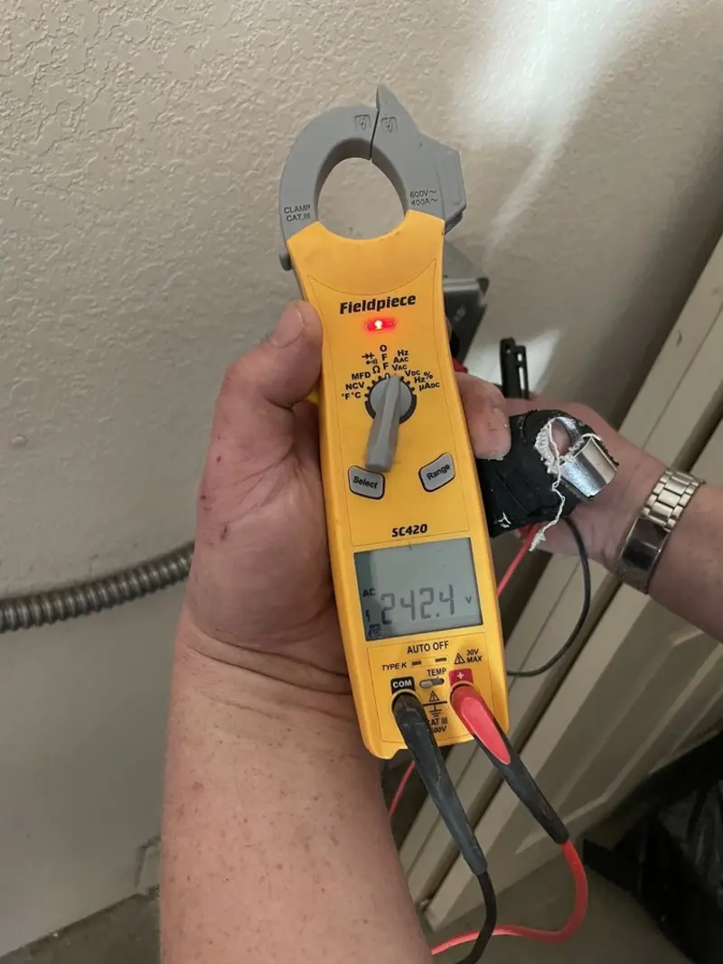 Voltage testing with clamp meter during Electrical Installation Services in Olga